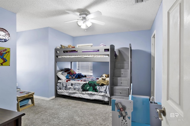 carpeted bedroom with ceiling fan and a textured ceiling