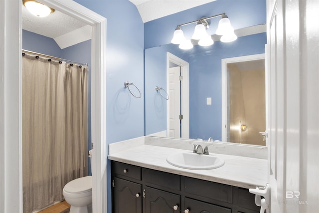 full bathroom with shower / tub combo with curtain, vanity, toilet, and a textured ceiling