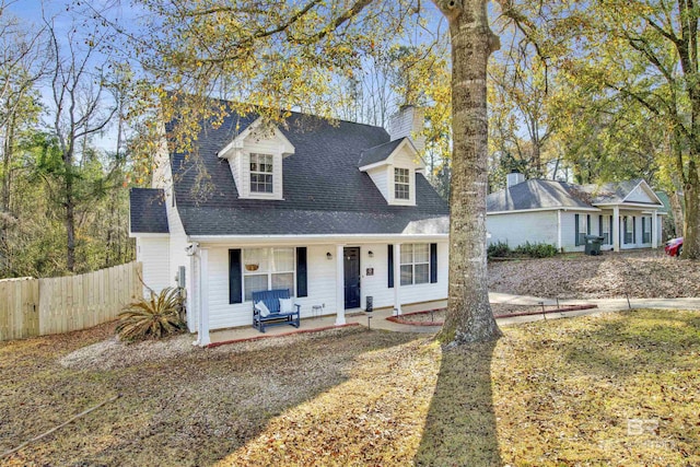 new england style home featuring covered porch