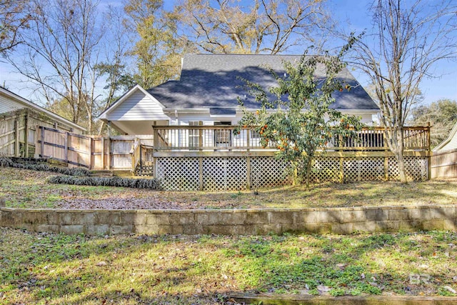 back of property with a wooden deck