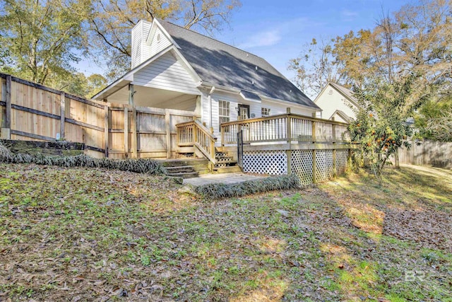 rear view of house featuring a deck