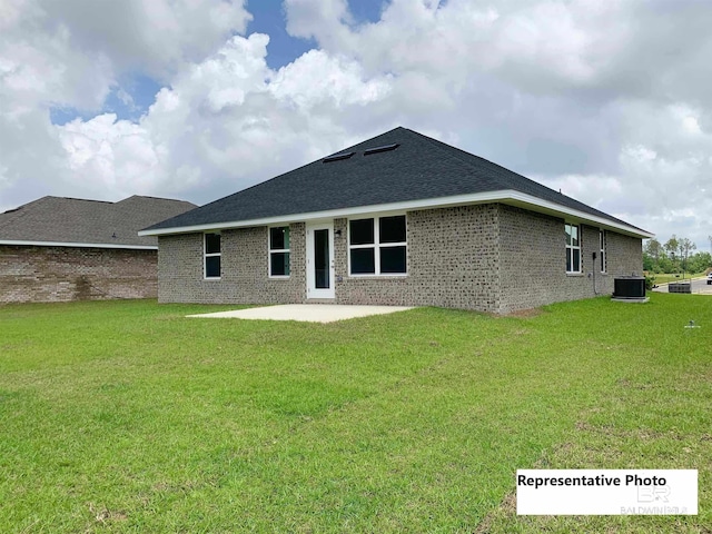 rear view of house with a yard, a patio, and cooling unit