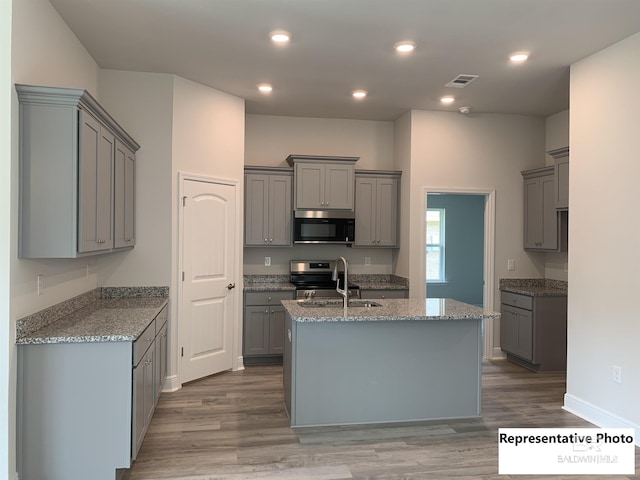 kitchen featuring gray cabinets and appliances with stainless steel finishes