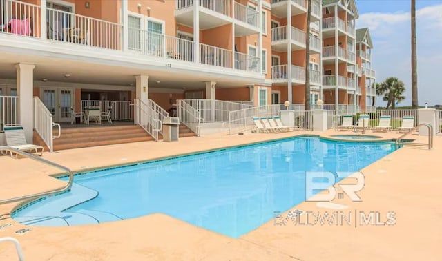 572 E Beach Blvd Unit 318, Gulf Shores, AL 36542 - community pool featuring a hot tub and a patio area