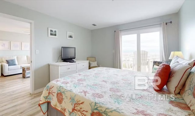 572 E Beach Blvd Unit 318, Gulf Shores, AL 36542 - bedroom featuring light wood-style flooring and baseboards
