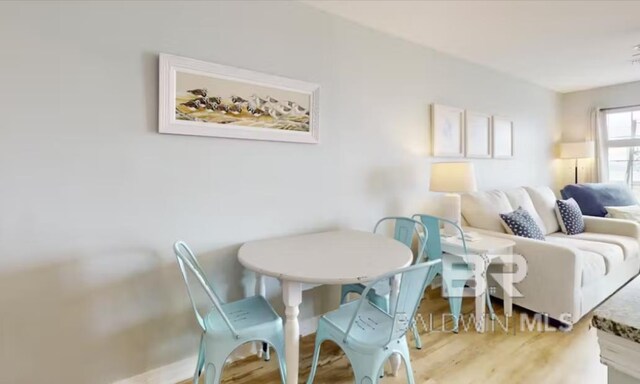 572 E Beach Blvd Unit 318, Gulf Shores, AL 36542 - dining area featuring wood finished floors