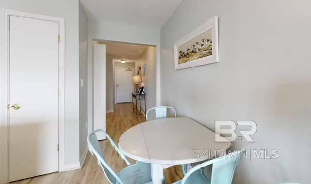 572 E Beach Blvd Unit 318, Gulf Shores, AL 36542 - dining room featuring light wood finished floors and baseboards