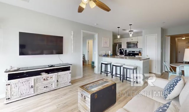 572 E Beach Blvd Unit 318, Gulf Shores, AL 36542 - living room with a ceiling fan and light wood finished floors