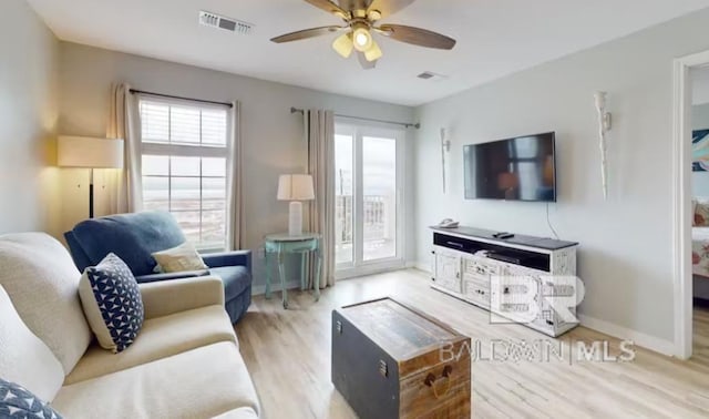 572 E Beach Blvd Unit 318, Gulf Shores, AL 36542 - living room with plenty of natural light, light wood-style flooring, a ceiling fan, and baseboards