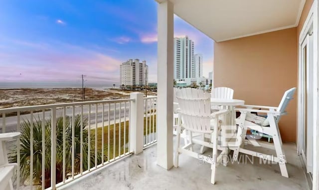 572 E Beach Blvd Unit 318, Gulf Shores, AL 36542 - balcony at dusk featuring a view of city