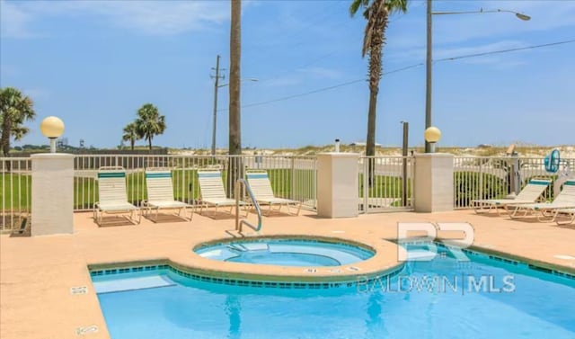 572 E Beach Blvd Unit 318, Gulf Shores, AL 36542 - community pool featuring a community hot tub and a patio