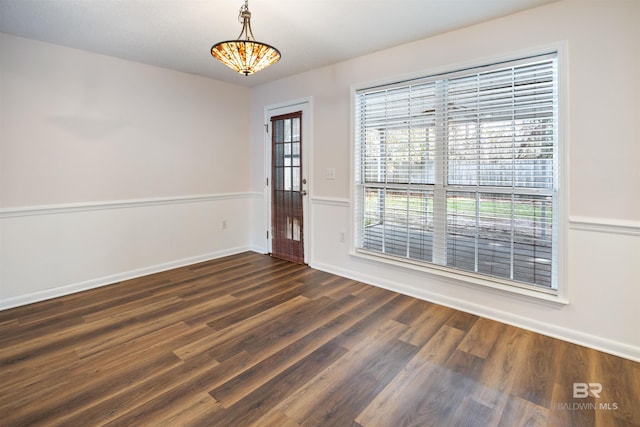 spare room featuring dark wood-type flooring