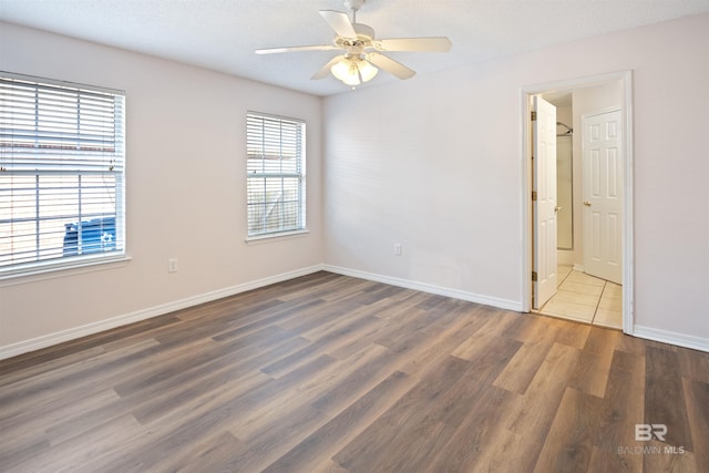 spare room featuring ceiling fan, dark hardwood / wood-style floors, and a textured ceiling