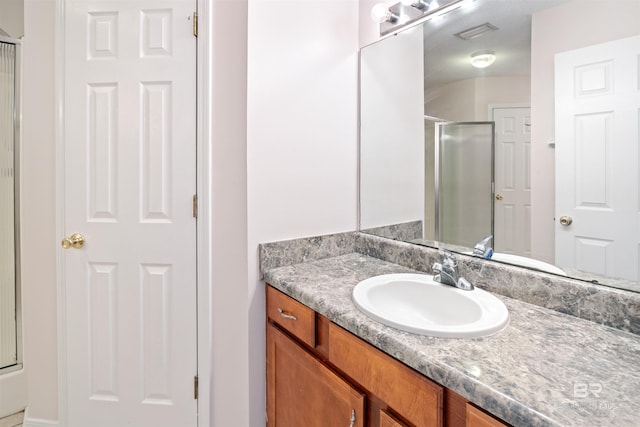 bathroom with an enclosed shower and vanity