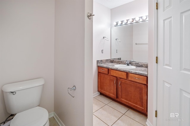 bathroom with vanity, tile patterned floors, and toilet