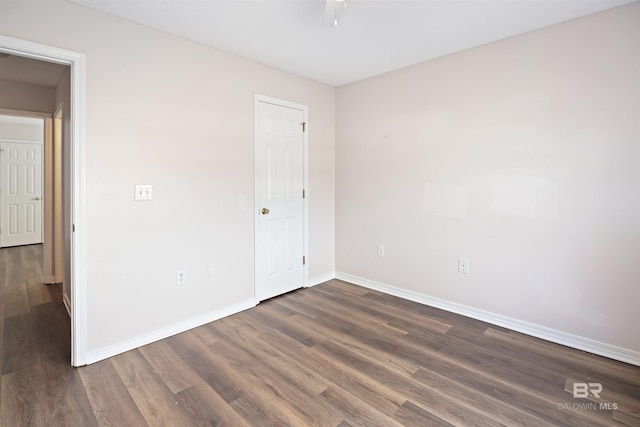 empty room featuring dark wood-type flooring