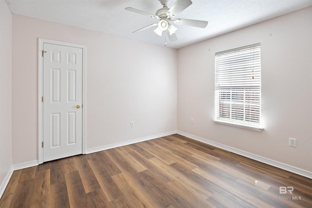 unfurnished room with dark hardwood / wood-style flooring, ceiling fan, and a textured ceiling