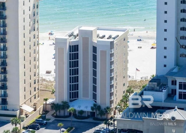 view of property featuring a water view and a view of the beach