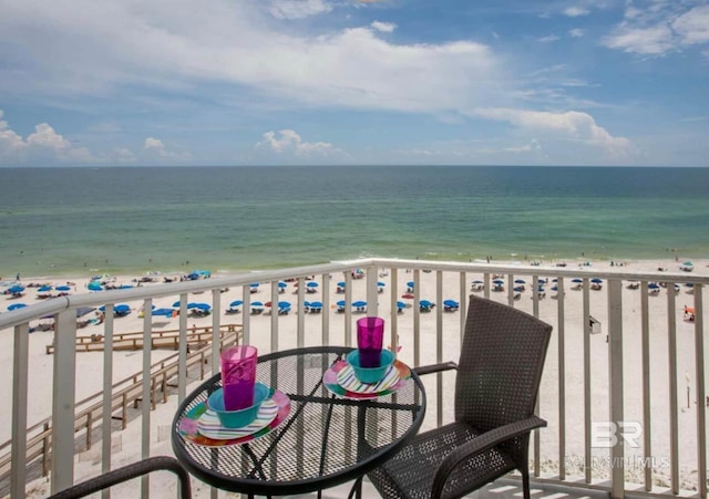 balcony with a view of the beach and a water view