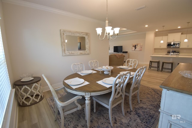 1123 Pheasant Cir, Foley, AL 36535 - dining space with crown molding, baseboards, wood finished floors, and a chandelier