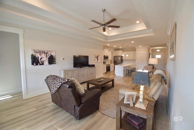 1123 Pheasant Cir, Foley, AL 36535 - living area with crown molding, ceiling fan, light wood-style flooring, and a raised ceiling