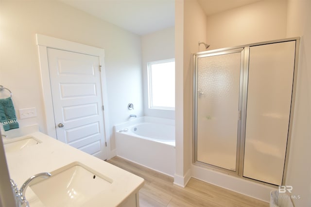 1123 Pheasant Cir, Foley, AL 36535 - bathroom with a sink, double vanity, wood finished floors, a bath, and a stall shower
