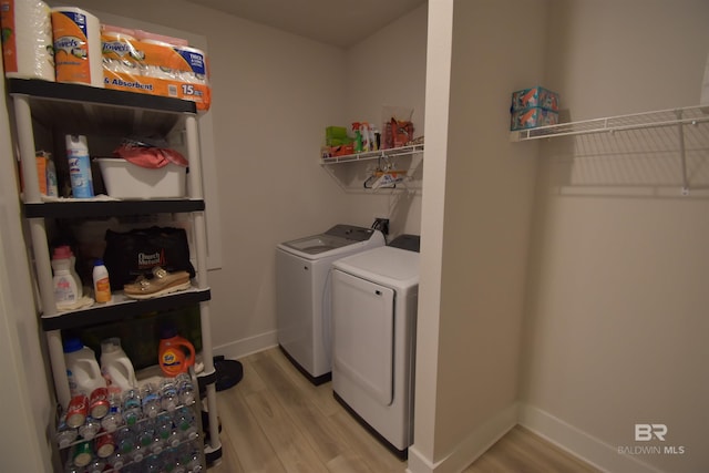 1123 Pheasant Cir, Foley, AL 36535 - washroom with washing machine and clothes dryer, laundry area, baseboards, and wood finished floors