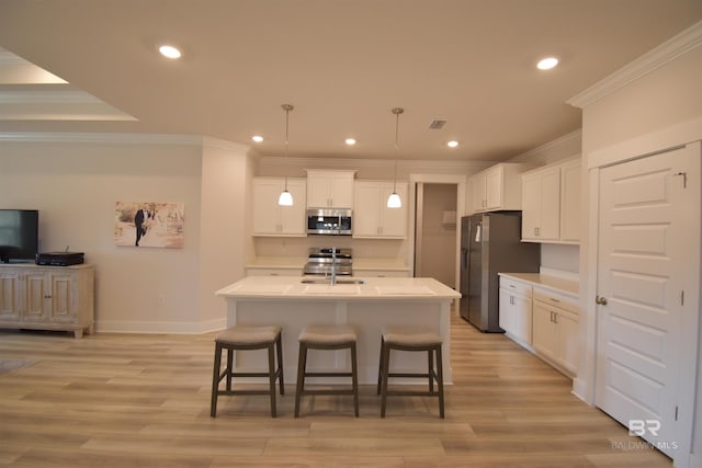 1123 Pheasant Cir, Foley, AL 36535 - kitchen with white cabinets, a breakfast bar area, stainless steel appliances, recessed lighting, and ornamental molding