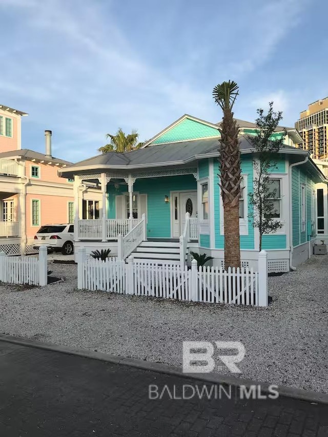 11 Meeting St, Orange Beach, AL 36561 - view of front of property with covered porch and a fenced front yard