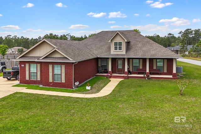 10210 Lyttleton Loop, Lillian, AL 36549 - view of front facade featuring a front lawn, a porch, brick siding, and a shingled roof
