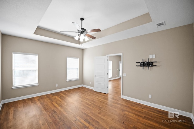 10210 Lyttleton Loop, Lillian, AL 36549 - unfurnished room featuring a ceiling fan, a tray ceiling, baseboards, visible vents, and wood finished floors