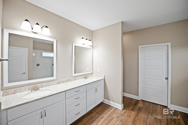 10210 Lyttleton Loop, Lillian, AL 36549 - full bath with double vanity, wood finished floors, baseboards, and a sink