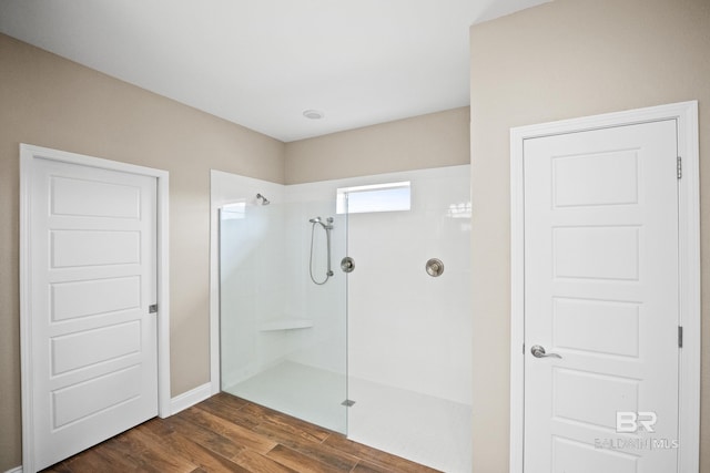 10210 Lyttleton Loop, Lillian, AL 36549 - bathroom featuring baseboards, wood finished floors, and a walk in shower