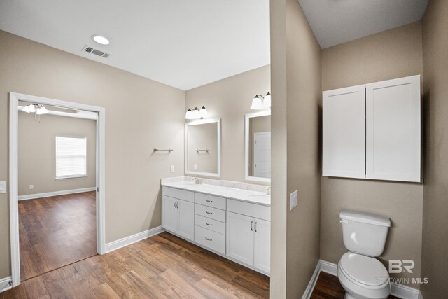 10210 Lyttleton Loop, Lillian, AL 36549 - bathroom featuring double vanity, visible vents, wood finished floors, and a sink