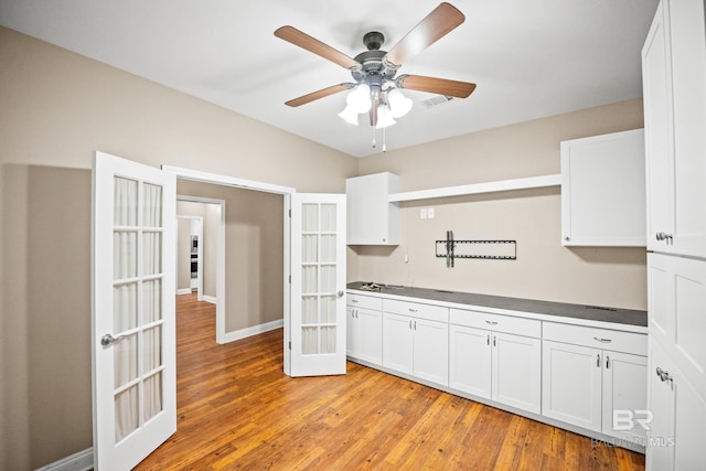 10210 Lyttleton Loop, Lillian, AL 36549 - kitchen with a ceiling fan, french doors, white cabinets, and light wood-style floors
