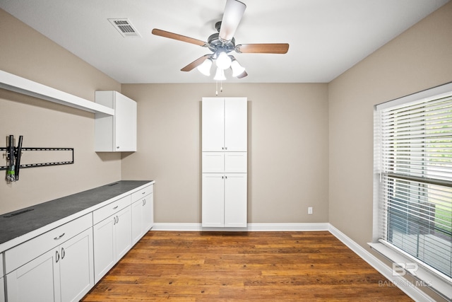 10210 Lyttleton Loop, Lillian, AL 36549 - kitchen featuring white cabinets, visible vents, baseboards, dark wood-type flooring, and ceiling fan