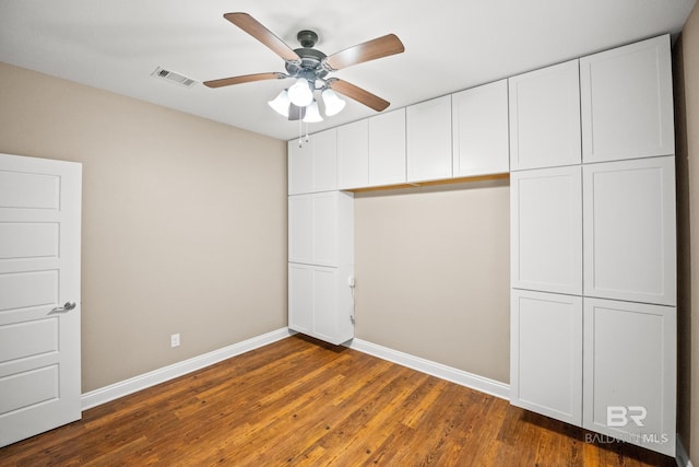 10210 Lyttleton Loop, Lillian, AL 36549 - unfurnished bedroom with baseboards, ceiling fan, visible vents, and dark wood-style floors