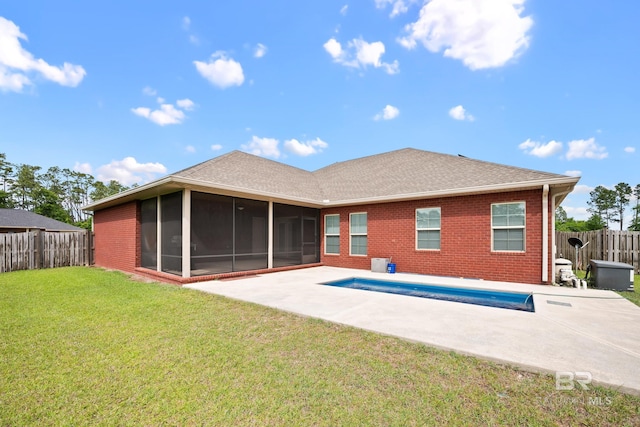 10210 Lyttleton Loop, Lillian, AL 36549 - rear view of house with a yard, brick siding, a patio, a sunroom, and a fenced backyard