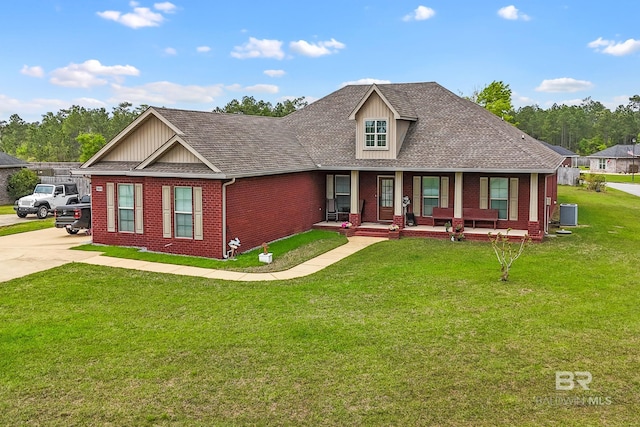 10210 Lyttleton Loop, Lillian, AL 36549 - view of front of home with covered porch, a shingled roof, a front lawn, and brick siding