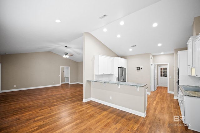 10210 Lyttleton Loop, Lillian, AL 36549 - kitchen with a peninsula, stainless steel refrigerator with ice dispenser, visible vents, light wood-style flooring, and a ceiling fan