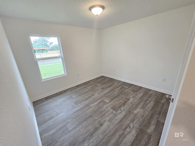 14530 Dayton Cir, Foley, AL 36535 - empty room with dark wood-type flooring, a textured ceiling, and baseboards