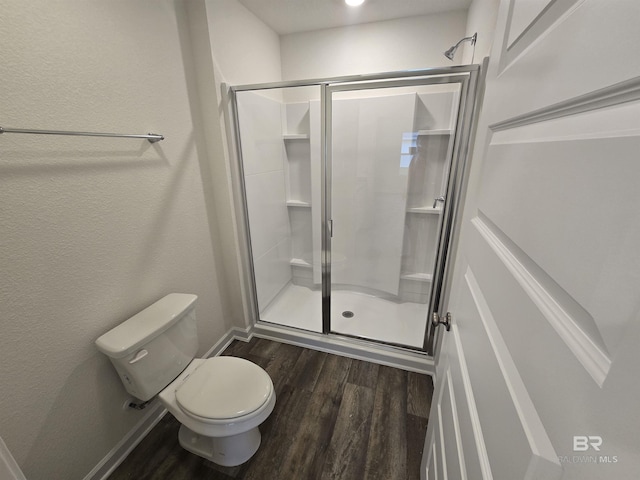 14530 Dayton Cir, Foley, AL 36535 - bathroom with wood finished floors, toilet, a shower stall, and baseboards