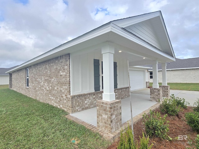 14530 Dayton Cir, Foley, AL 36535 - view of home's exterior with brick siding, a porch, driveway, and a yard