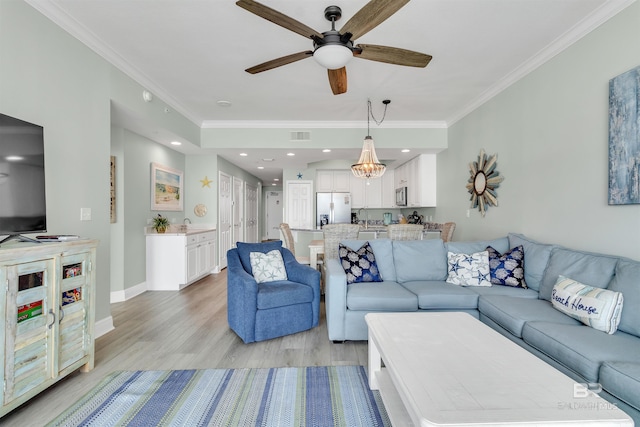 living room featuring recessed lighting, baseboards, light wood-style floors, and crown molding