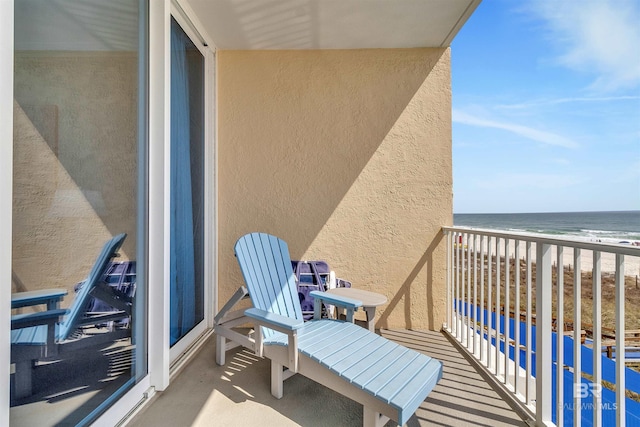 balcony with a beach view and a water view