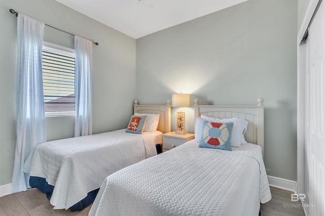 bedroom with baseboards and wood finished floors