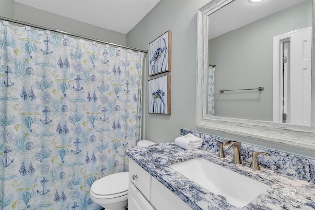 bathroom with a shower with shower curtain, toilet, and vanity