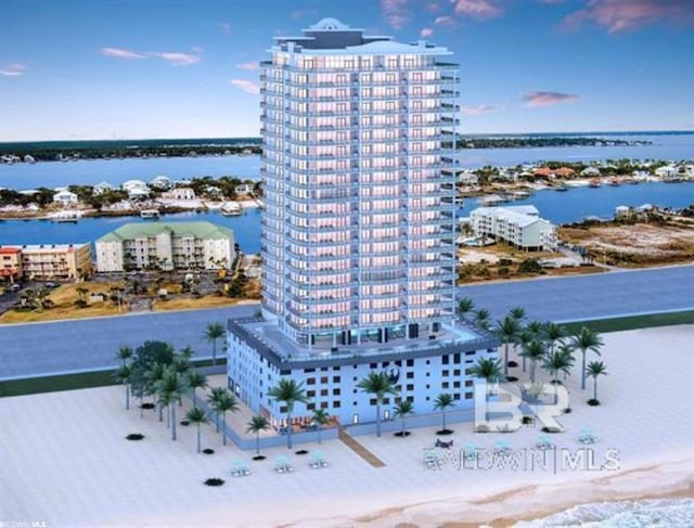 birds eye view of property with a water view and a city view