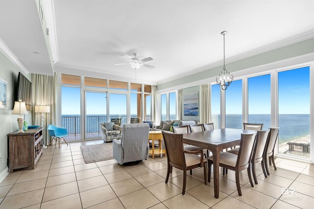 sunroom with a ceiling fan, a water view, and a wealth of natural light