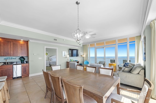 dining area with baseboards, visible vents, light tile patterned flooring, ornamental molding, and a chandelier